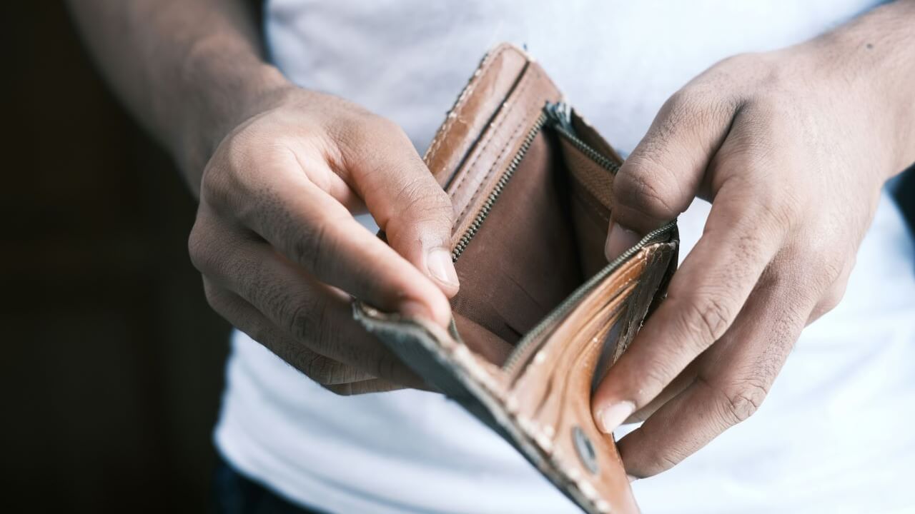 Man Holding Empty Wallet