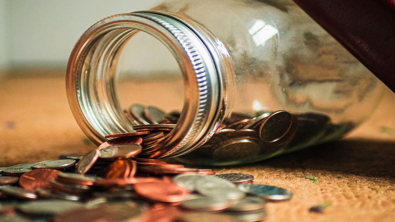 Coins Spilling from Jar